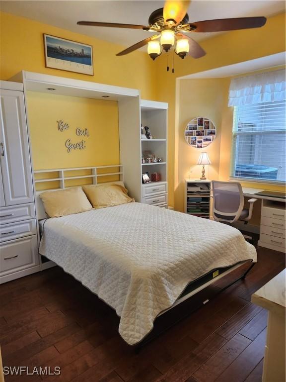 bedroom with dark wood-type flooring and a ceiling fan