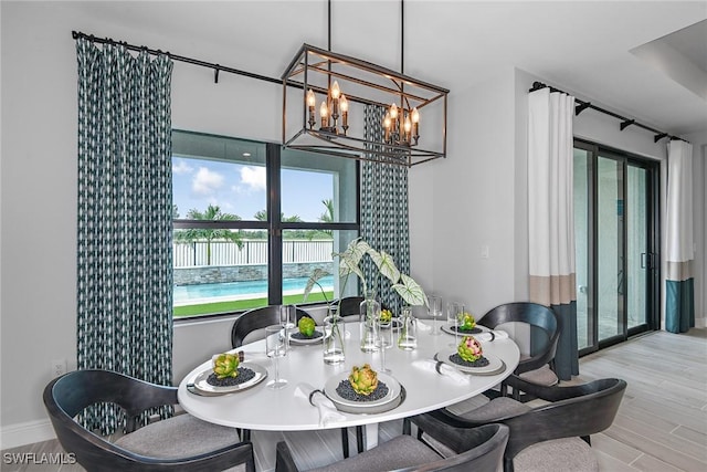 dining space with an inviting chandelier and light wood-type flooring