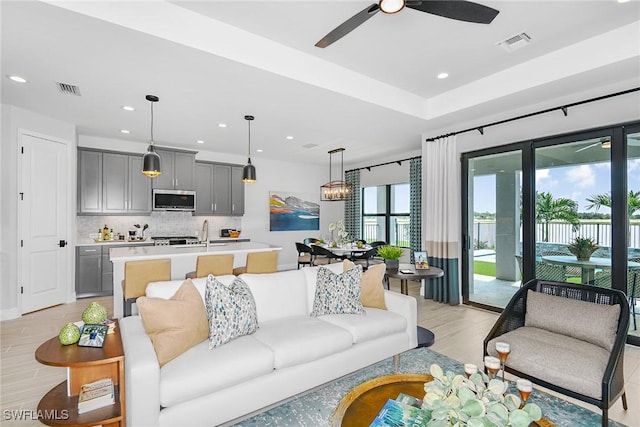 living room featuring ceiling fan and light wood-type flooring