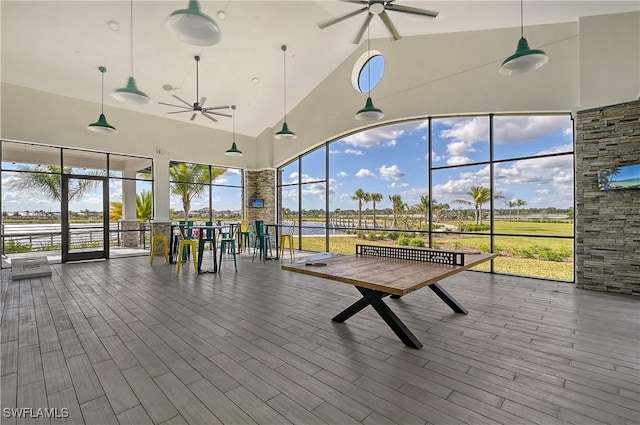 unfurnished sunroom with ceiling fan