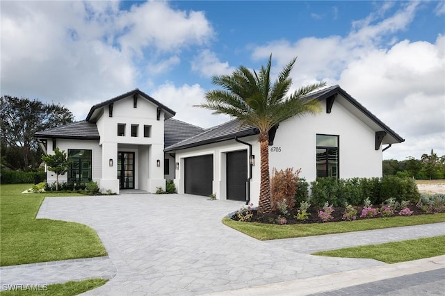 6705 Newport Rd, Naples, FL 34109 - view of front of house with a garage, stucco siding, decorative driveway, a front lawn, and french doors