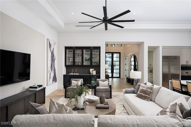 living room featuring ceiling fan, crown molding, french doors, and light hardwood / wood-style flooring