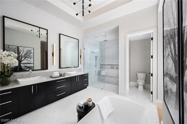 6705 Newport Rd, Naples, FL 34109 - bathroom featuring walk in shower, double vanity, toilet, and baseboards