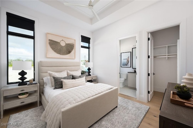 6705 Newport Rd, Naples, FL 34109 - bedroom with wood finished floors, ensuite bath, a spacious closet, and a closet