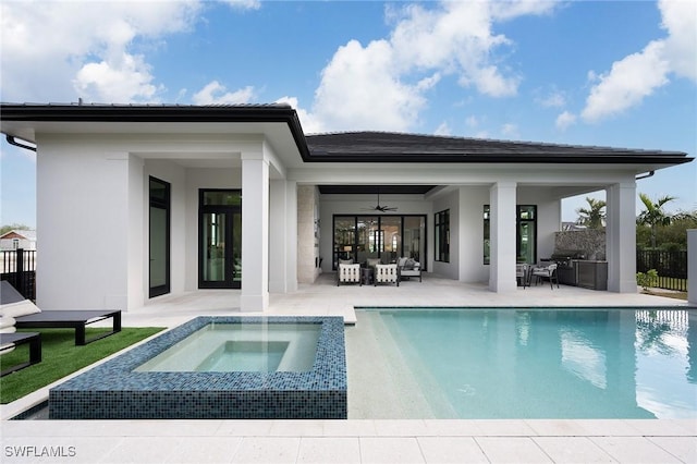 6705 Newport Rd, Naples, FL 34109 - rear view of house with a patio, ceiling fan, an outdoor hangout area, stucco siding, and an in-ground hot tub
