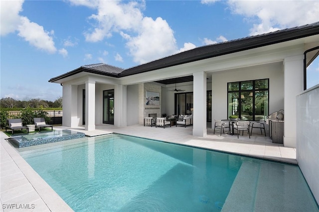 6705 Newport Rd, Naples, FL 34109 - rear view of house featuring outdoor lounge area, ceiling fan, a patio area, a pool with connected hot tub, and stucco siding