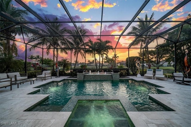 view of patio / terrace with a lanai, grilling area, ceiling fan, and area for grilling