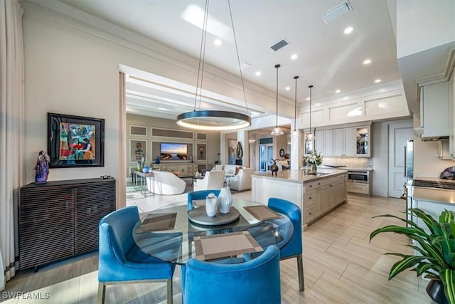 dining area with ornamental molding, a wealth of natural light, and ceiling fan with notable chandelier