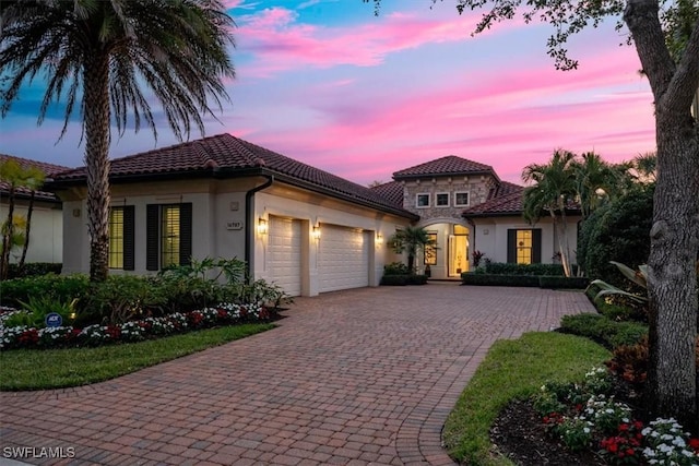 mediterranean / spanish house with a garage