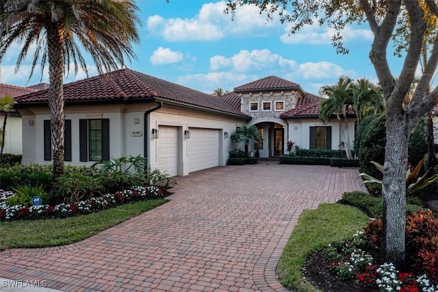 mediterranean / spanish home with a garage