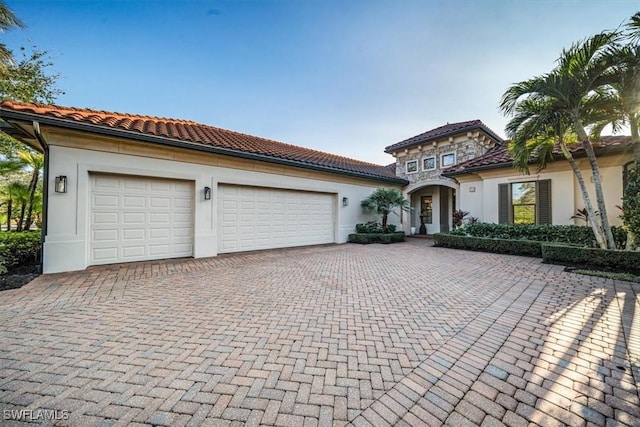 mediterranean / spanish house with a garage