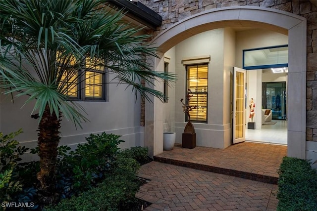 entrance to property featuring a patio