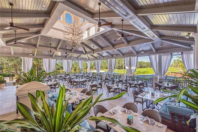 view of home's community with a gazebo and ceiling fan with notable chandelier