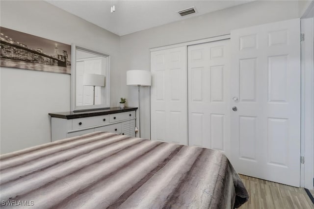 bedroom featuring light hardwood / wood-style flooring and a closet