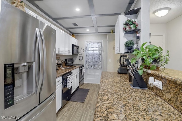 kitchen featuring coffered ceiling, black appliances, white cabinets, sink, and dark stone countertops