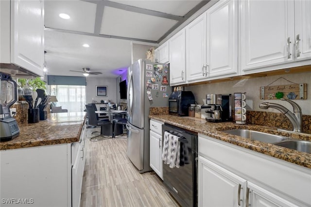 kitchen with a sink, white cabinetry, dishwasher, and freestanding refrigerator