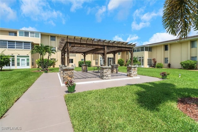 view of community featuring a lawn and a pergola