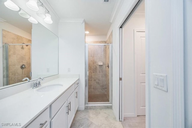 full bathroom featuring a stall shower, vanity, and crown molding