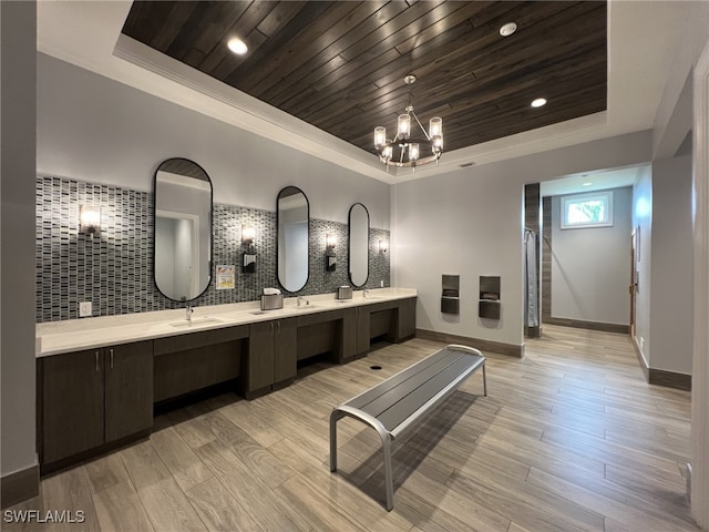 bathroom featuring hardwood / wood-style flooring, a tray ceiling, wood ceiling, and vanity