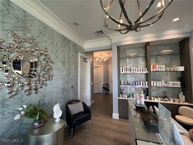 interior space with dark hardwood / wood-style flooring, a notable chandelier, crown molding, and built in features