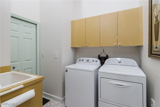6750 Beach Resort Dr Unit 10, Naples, FL 34114 - laundry area featuring light tile patterned floors, separate washer and dryer, and cabinet space