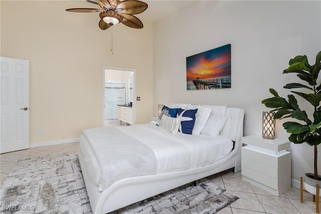 6750 Beach Resort Dr Unit 10, Naples, FL 34114 - bedroom with connected bathroom, ceiling fan, baseboards, a high ceiling, and light tile patterned flooring