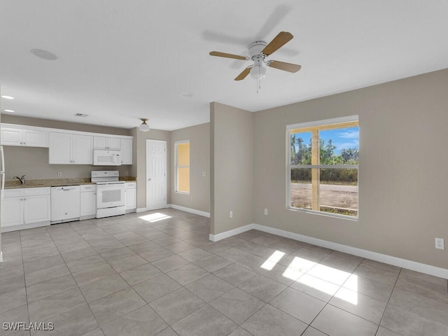 unfurnished living room with ceiling fan, light tile patterned flooring, and sink