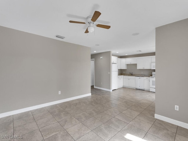 unfurnished living room featuring ceiling fan, sink, and light tile patterned floors