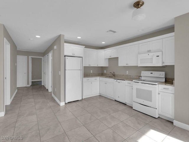 kitchen with white cabinetry, light tile patterned floors, light stone countertops, and white appliances