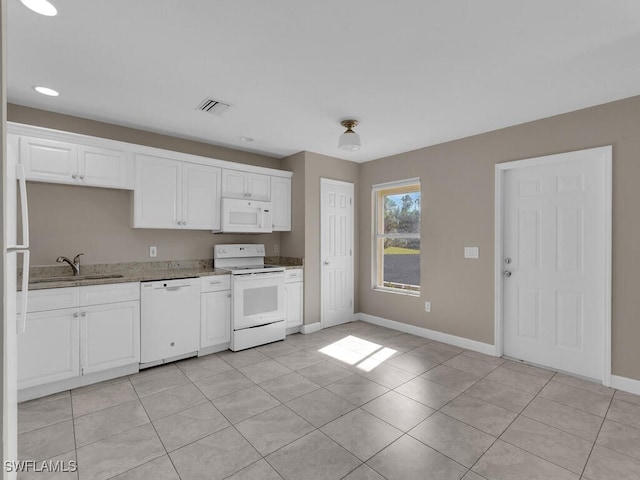 kitchen with white cabinetry, sink, stone countertops, white appliances, and light tile patterned flooring