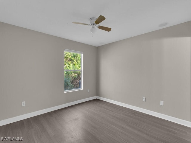 empty room with ceiling fan and dark wood-type flooring