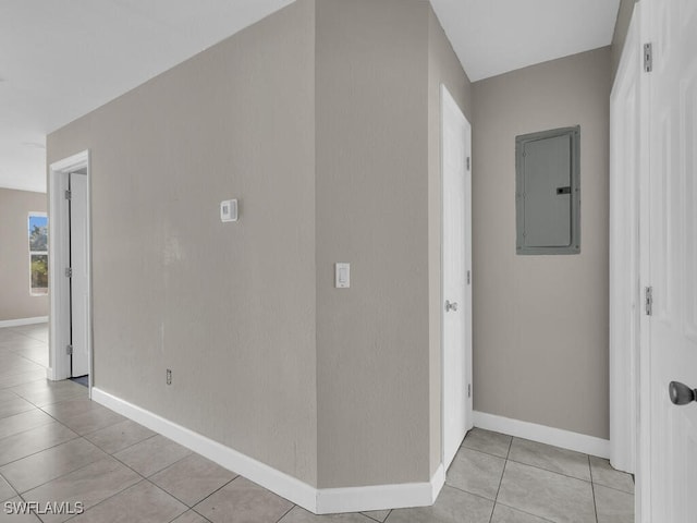 hallway with light tile patterned flooring and electric panel