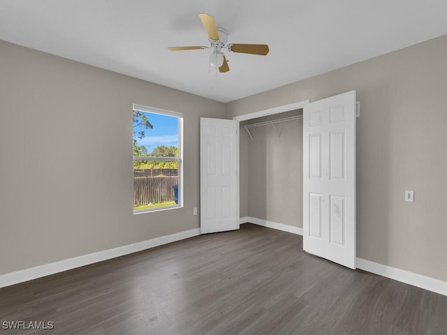 unfurnished bedroom featuring a closet, ceiling fan, and dark hardwood / wood-style floors