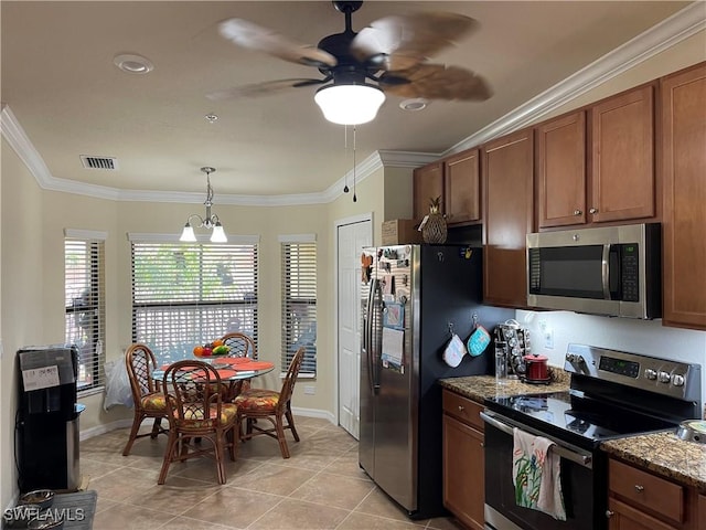 kitchen with ceiling fan with notable chandelier, stainless steel appliances, light tile patterned floors, decorative light fixtures, and dark stone countertops