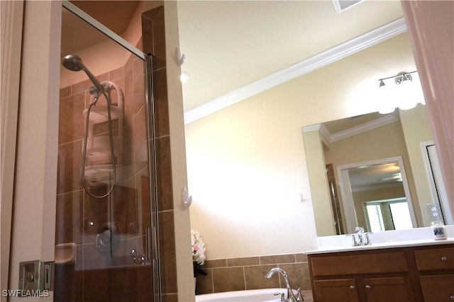 full bathroom with ornamental molding, a shower stall, a bath, and vanity