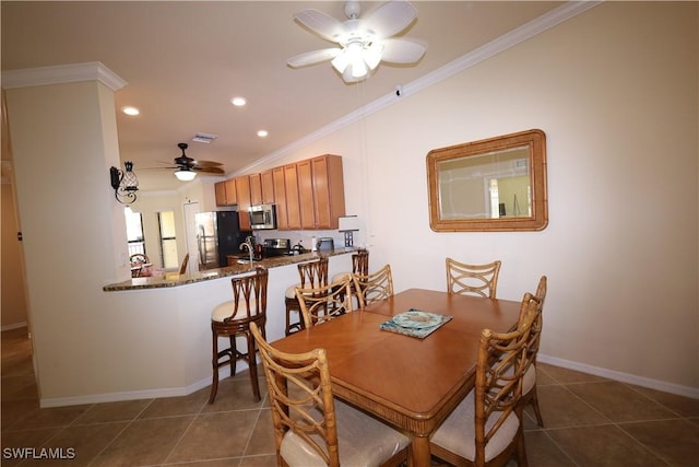dining area with recessed lighting, dark tile patterned floors, ornamental molding, baseboards, and a ceiling fan