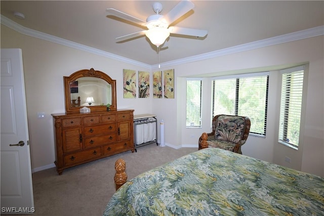 bedroom with crown molding, baseboards, a ceiling fan, and carpet floors