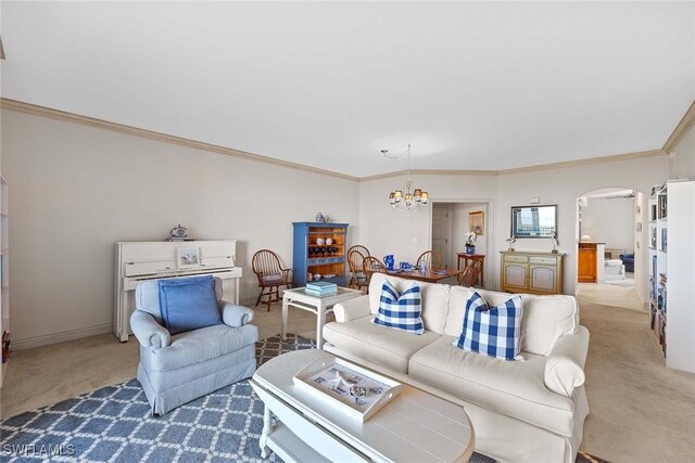 living room featuring light colored carpet, ornamental molding, and an inviting chandelier