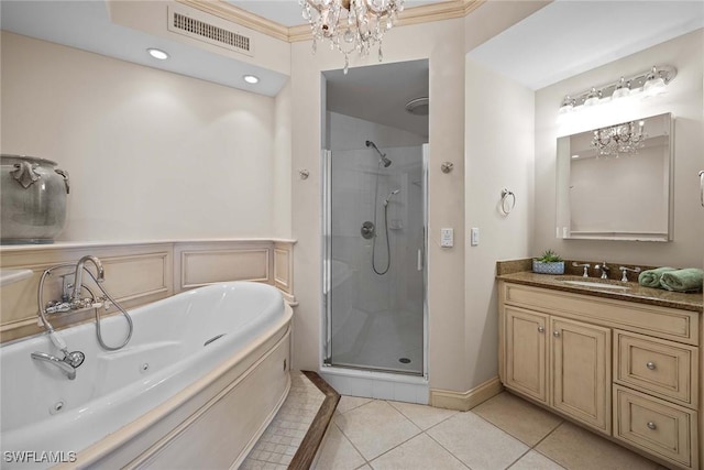 bathroom with a chandelier, vanity, separate shower and tub, and tile patterned floors