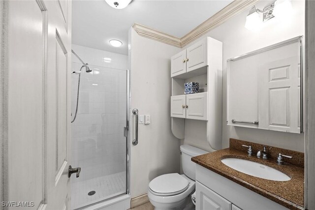 bathroom featuring crown molding, toilet, vanity, and walk in shower