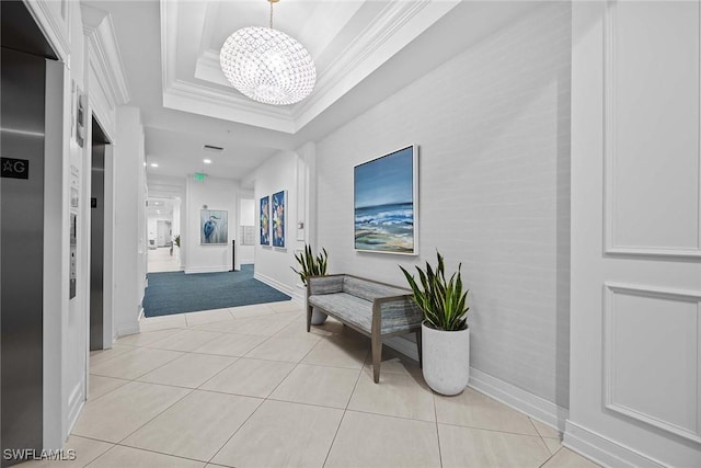 corridor with a notable chandelier, light tile patterned flooring, a raised ceiling, and crown molding