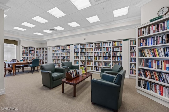 living area featuring light carpet, built in features, and ornamental molding