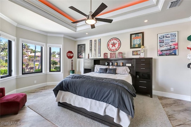 bedroom featuring a tray ceiling, ceiling fan, and ornamental molding