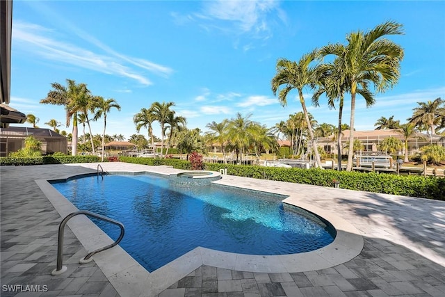 view of pool with an in ground hot tub and a patio