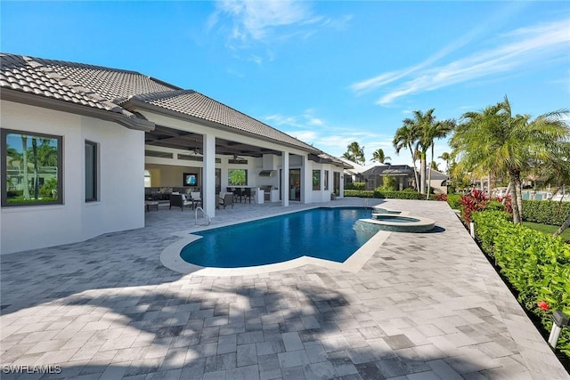 view of swimming pool with a patio area, an in ground hot tub, and ceiling fan