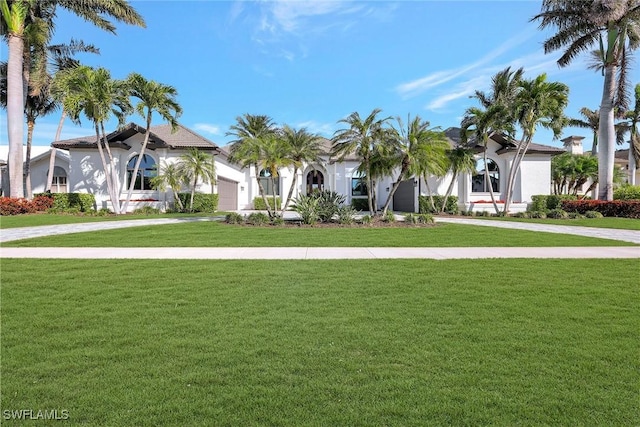 mediterranean / spanish-style home with a front yard