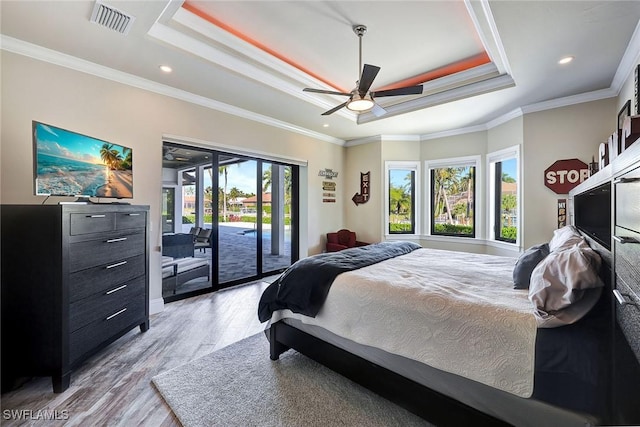 bedroom with a tray ceiling, ceiling fan, and crown molding