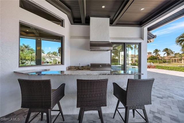 view of patio featuring area for grilling and an outdoor wet bar