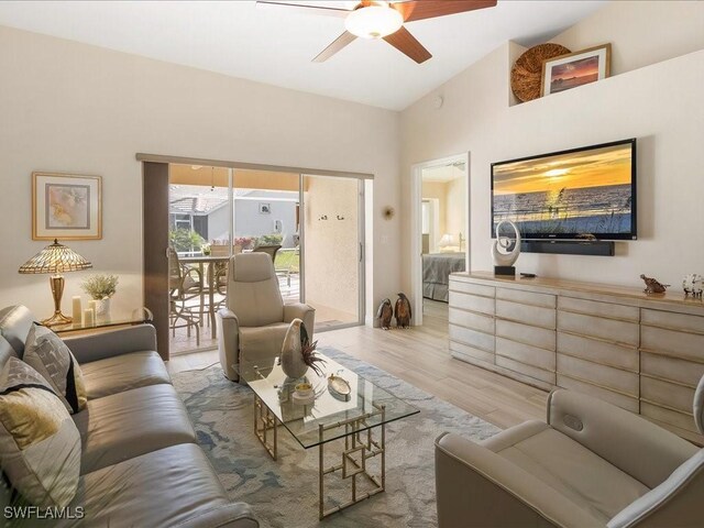 living room featuring ceiling fan and light wood-type flooring