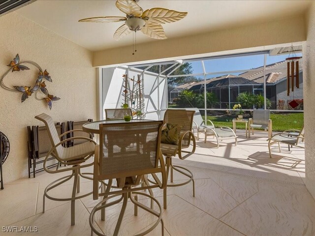 sunroom / solarium featuring ceiling fan